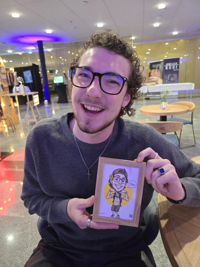 Bezoeker met zijn ingelijste karikatuur met de wens Moh
